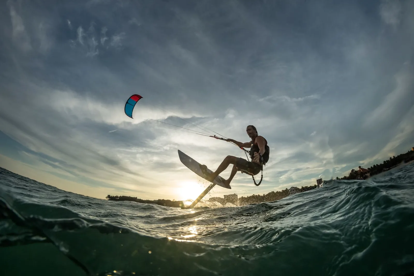 A young while male kite surfing
