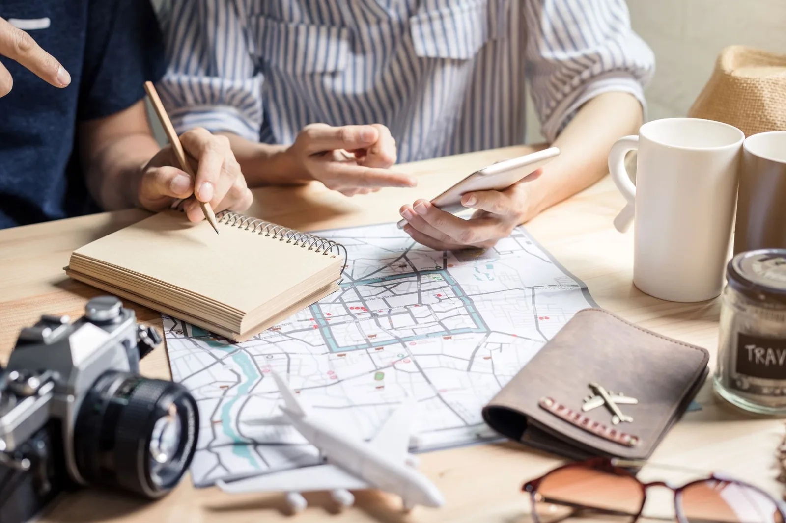 Young couple doing Family Road Trip Planning - planning vacation trip